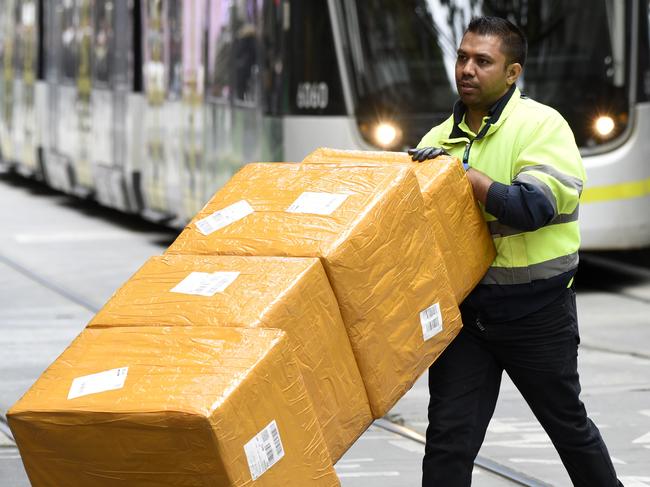 MELBOURNE, AUSTRALIA - NewsWire Photos DECEMBER 15, 2022: ABS generics - A delivery driver with boxes in the Bourke Street Mall in central Melbourne. Picture: NCA NewsWire / Andrew Henshaw