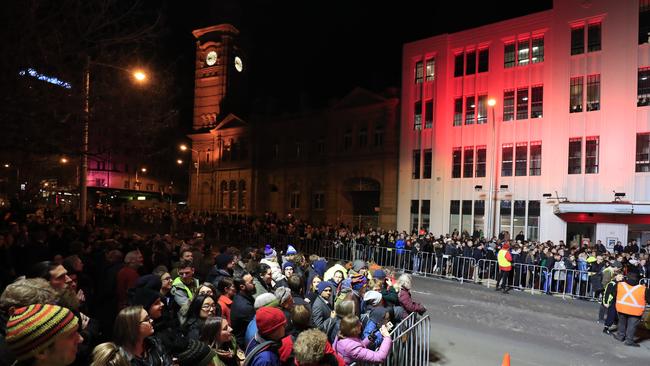 Crowds witness Hobart's Macquarie St being excavated to encase artist Mike Parr. Picture: AAP