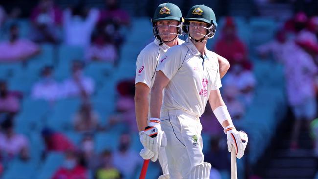 Australia's Steven Smith (R) and Marnus Labuschagne watch a replay for the Leg-Before-Wicket (LBW) appeal decision on the third day of the third cricket Test match between Australia and India at the Sydney Cricket Ground (SCG) in Sydney on January 9, 2021. (Photo by DAVID GRAY / AFP)