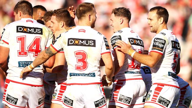 Cameron McInnes celebrates with Dragons teammates after scoring a try.