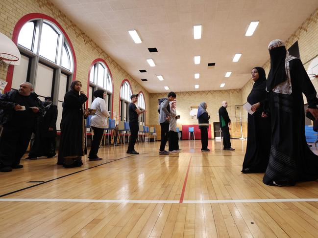 DEARBORN, MICHIGAN - NOVEMBER 05: Voters wait in line to vote at the Lowrey School on November 5, 2024 in Dearborn, Michigan. Americans cast their ballots today in the presidential race between Republican nominee former President Donald Trump and Democratic nominee Vice President Kamala Harris, as well as multiple state elections that will determine the balance of power in Congress.   Gregory Shamus/Getty Images/AFP (Photo by Gregory Shamus / GETTY IMAGES NORTH AMERICA / Getty Images via AFP)