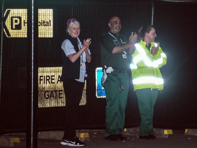 NHS workers applaud outside St Thomas' Hospital as Boris Johnson is moved to intensive care. Picture: AP.