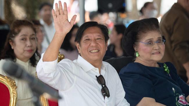 Philippine President Ferdinand Marcos waves as he sits with his mother, former first lady Imelda Marcos, as they visit the tomb of former president Ferdinand Marcos Sr after a mass to commemorate All Saints' Day at the Heroes Cemetery in Manila on November 1. Picture: AFP