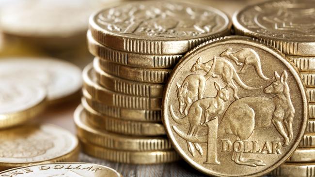 Stacks of Australian one dollar coins. Focus on front coin.