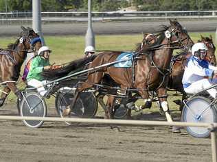 KEEPING PACE: Lola Weidemann (green) driving at Clifford Park.  She will drive a pacer in each heat tomorrow at the Warwick Show. Picture: Nev Madsen