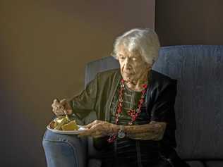 Winifred Jefferies, spends a quiet moment with a piece of cake as she prepares to celebrate her 107th birthday. Picture: Adam Hourigan