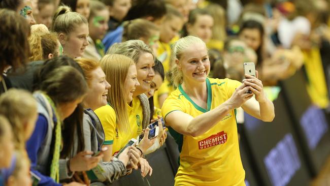 Diamonds Jo Weston takes a selfie with fans after the game against Silver Ferns at the Launceston Silverdome. Picture Chris Kidd