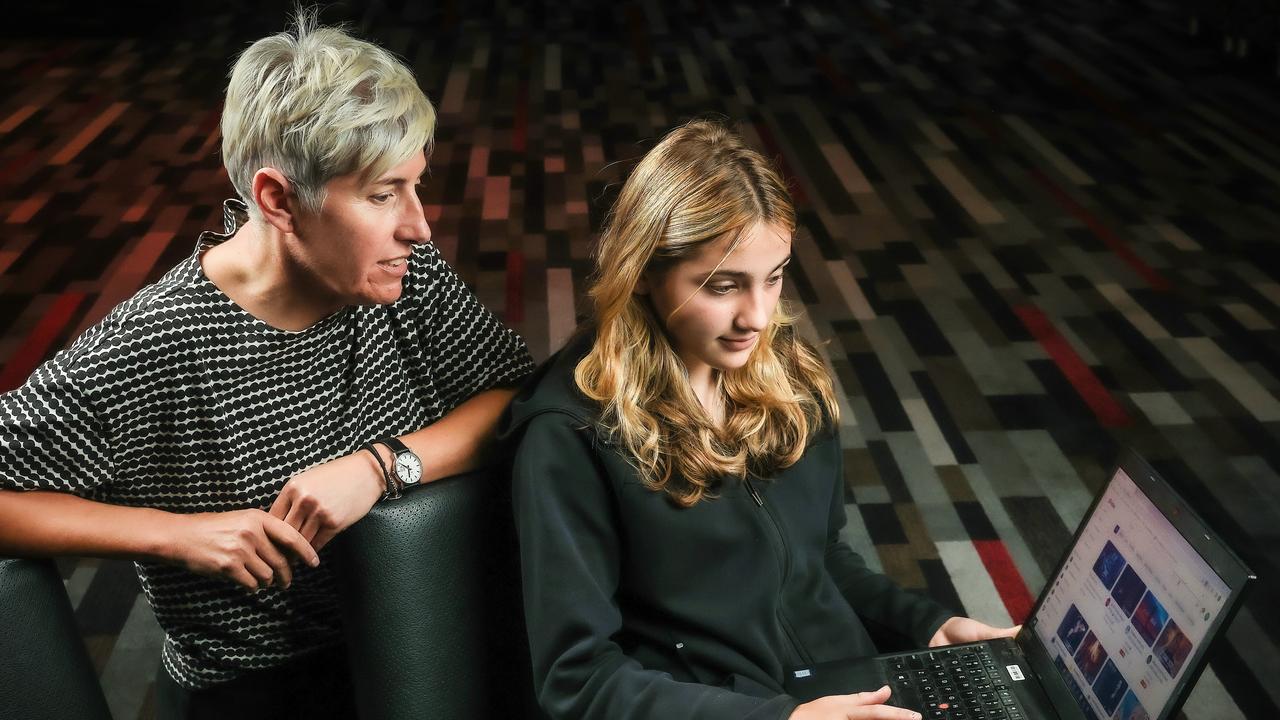 Perdie Bailey observes her daughter Maisie, 13, on the laptop. Picture: Ian Currie