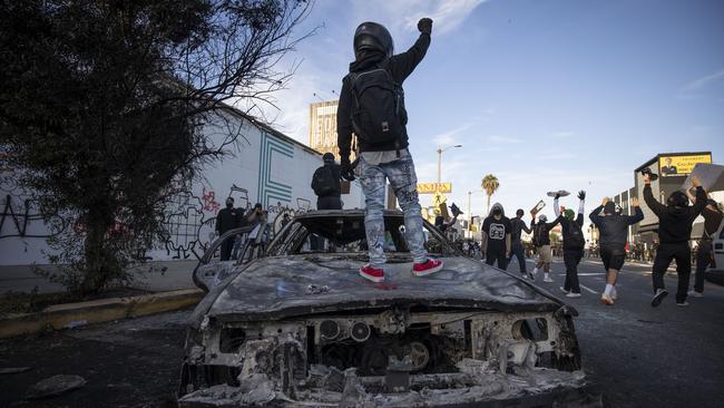 Protesters clash with police officers during a protest in Los Angeles.