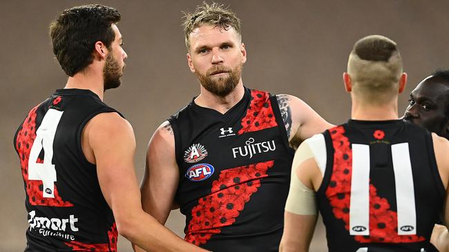 MELBOURNE, AUSTRALIA - JULY 03: Jake Stringer of the Bombers is congratulated by team mates after kicking a goal during the round 5 AFL match between the Collingwood Magpies and he Essendon Bombers at Melbourne Cricket Ground on July 03, 2020 in Melbourne, Australia. (Photo by Quinn Rooney/Getty Images)