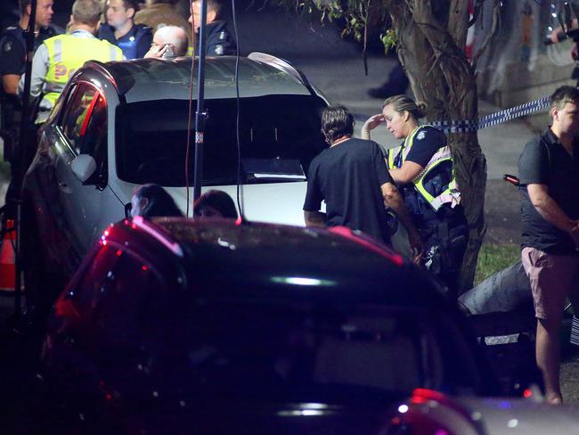 Police speak to witnesses. Photo: Patrick Herve