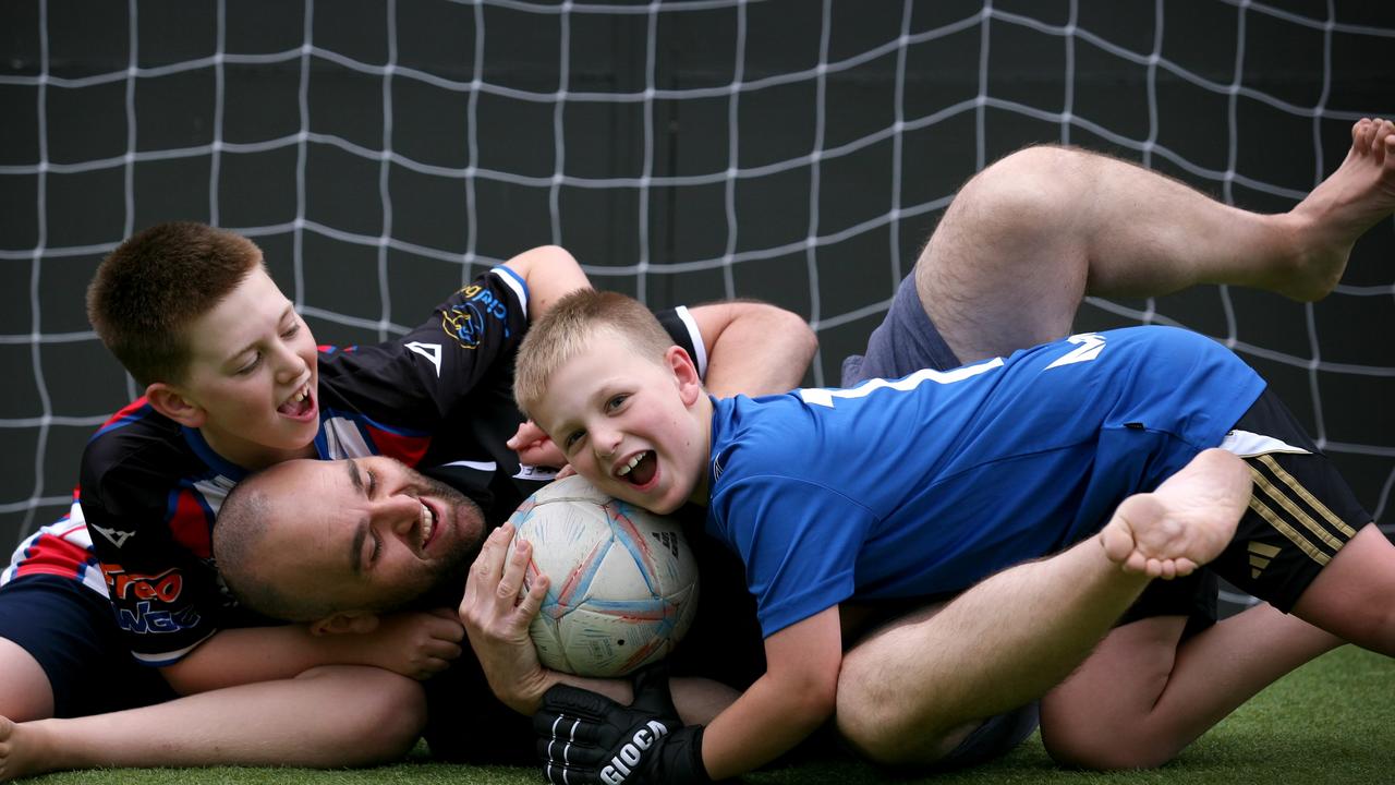 Steve Fazio plays soccer with his sons Lucas, 11, and Zac, 9, in their backyard. Picture Jeff Darmanin