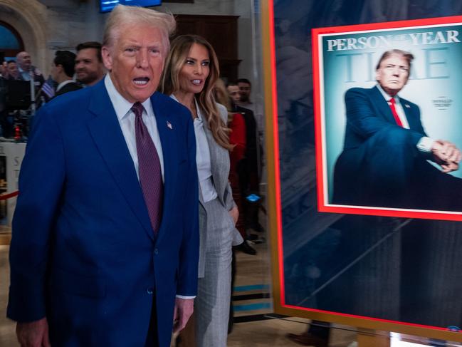 NEW YORK, NEW YORK - DECEMBER 12: President-elect Donald Trump walks onto the floor of the New York Stock Exchange (NYSE) with his wife Melania, after being named TIMEâs âPerson of the Yearâ for the second time on December 12, 2024 in New York City. Trump attended a reception and rang the opening bell on the trading floor.   Spencer Platt/Getty Images/AFP (Photo by SPENCER PLATT / GETTY IMAGES NORTH AMERICA / Getty Images via AFP)