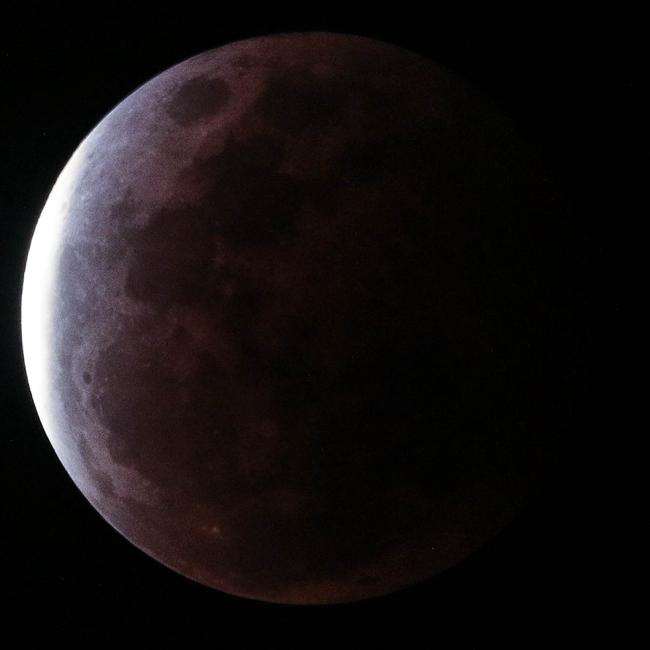 The super blood full moon seen over Darwin on Wednesday night. Pictures: Glenn Campbell