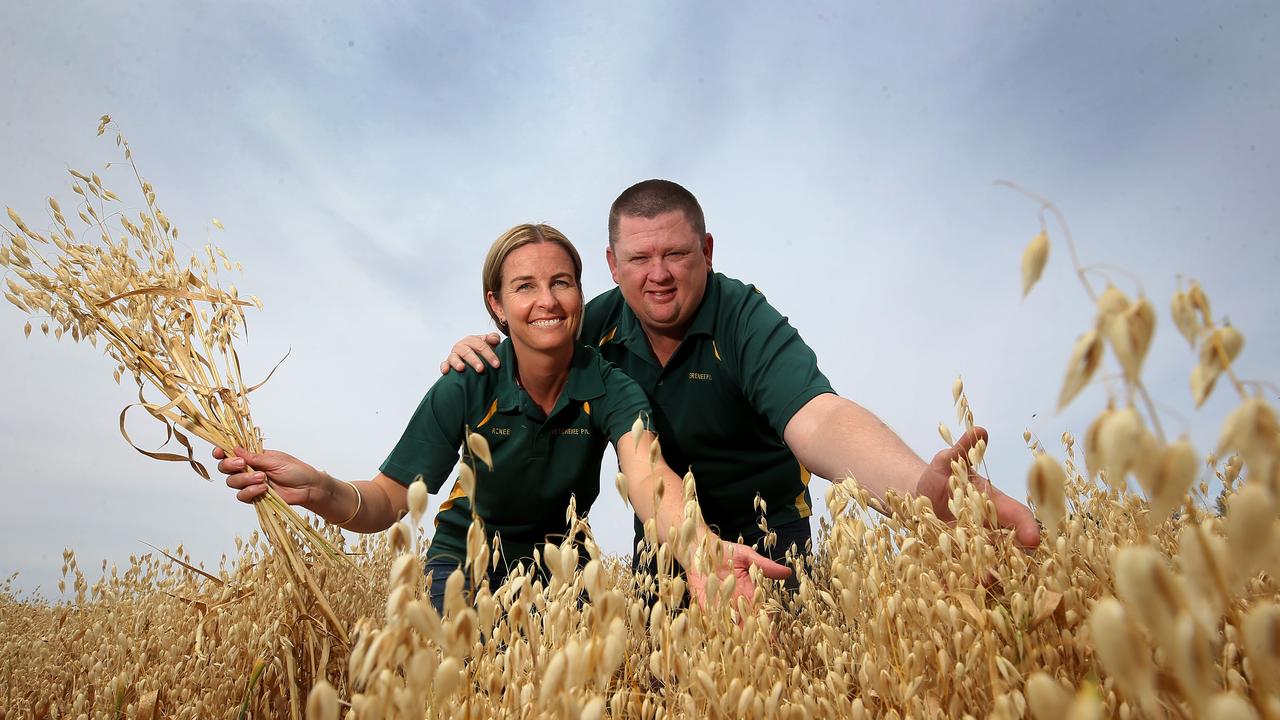 Growing passion: Peter and Renee Burke in a crop at their farm at Jerilderie, in NSW, where they grow oats, barley and rice. Picture: Yuri Kouzmin