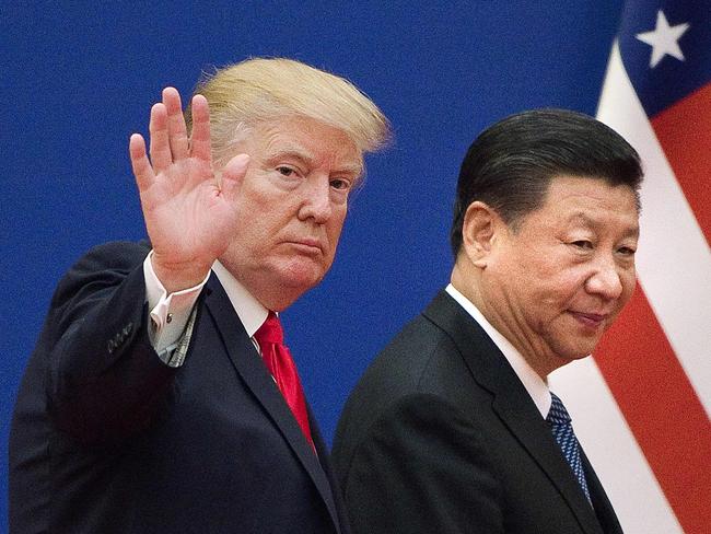 (FILES) This file picture taken on November 9, 2017 shows US President Donald Trump (L) and China's President Xi Jinping leaving a business leaders event at the Great Hall of the People in Beijing. - President Donald Trump hit back at China on August 23, 2019, in their mounting trade war, raising existing and planned tariffs in retaliation for Beijing's announcement earlier in the day of new duties on American goods. (Photo by Nicolas ASFOURI / AFP)