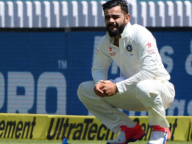 India's captain Virat Kohli reacts after he was injured while fielding during the first day of the third Test cricket match between India and Australia at The Jharkhand State Cricket Association (JSCA) Stadium Complex in Ranchi on March 16, 2017. ----IMAGE RESTRICTED TO EDITORIAL USE-STRICTLY NO COMMERCIAL USE----- / GETTYOUT / AFP PHOTO / SAJJAD HUSSAIN / ----IMAGE RESTRICTED TO EDITORIAL USE - STRICTLY NO COMMERCIAL USE----- / GETTYOUT