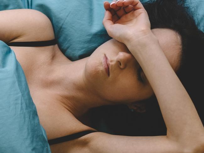 Depressed woman in bed with hand on forehead  Picture: istock