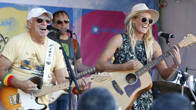 Singer Jimmy Buffett singing with Stephanie Gilmore at the Quiksivler Pro, Snapper Rocks. Picture: JERAD WILLIAMS