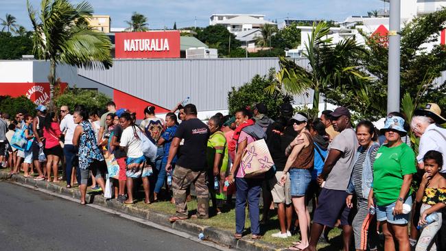 People queue to enter a supermarket to purchase groceries and food in the Magenta district of Noumea. Picture: Theo Rouby/AFP