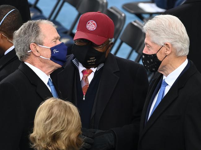 Former US President George W Bush, left, Jym Clyburn from South Carolina, centre, and former US President Bill Clinton, right, speak ahead of the inauguration ceremony. Picture: AFP