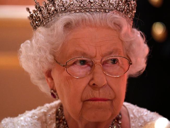 Britain's Queen Elizabeth II listens during speeches in the Picture Gallery for The Queen's Dinner during The Commonwealth Heads of Government Meeting (CHOGM), at Buckingham Palace in London on April 19, 2018.  Britain's Queen Elizabeth II, accompanied by Britain's Prince Charles, Prince of Wales, will receive Commonwealth Heads of Government and their spouses in the Blue Drawing Room, where the evening commences with a drinks reception. The dinner will take place in the Picture Gallery where Her Majesty will give a speech. / AFP PHOTO / POOL / Toby Melville