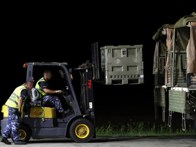 Australian military personnel load food and supplies onto trucks flown in from Darwin by a Hercules aircraft to Christmas Island. Picture: AAP