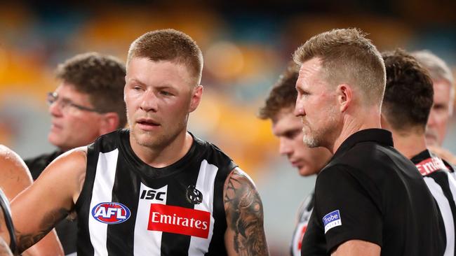 Jordan De Goey speaks with Collingwood coach Nathan Buckley in the loss to Port Adelaide.