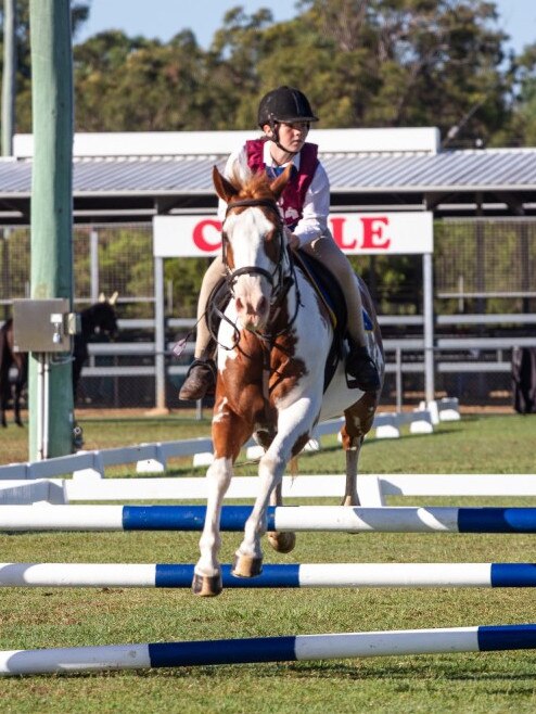 Mackenzie Westbury and her paint pony clear the oxer at the PQC State Showjumping Championships 2023.