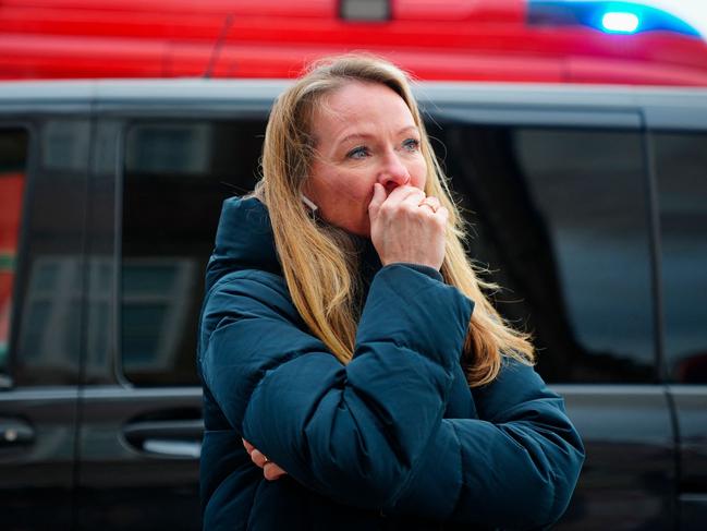 A woman reacts to a fire in the historic Borsen building in central Copenhagen, Denmark. The building was erected in the 1620s by King Christian IV and is located next to the Danish parliament. Picture: AFP