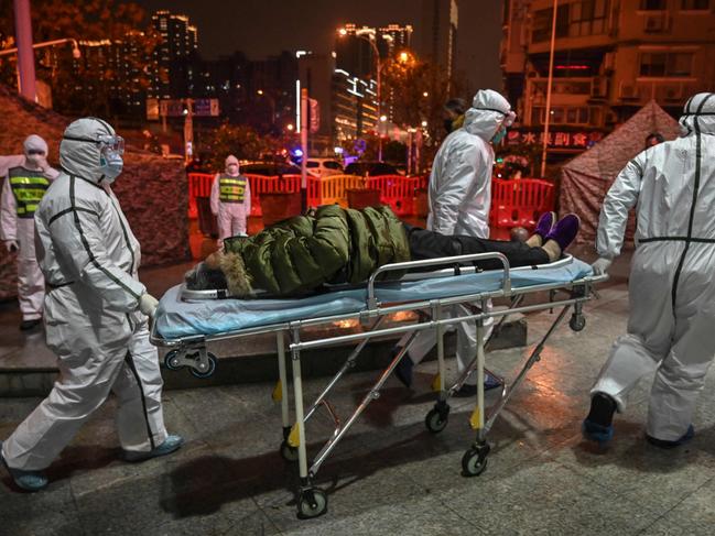 Medical staff members with a patient at a Wuhan hospital. Picture: AFP