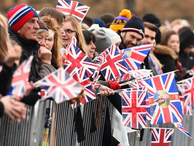 Crowds wait for the arrival of the popular couple. Picture: AFP/Andy Buchanan