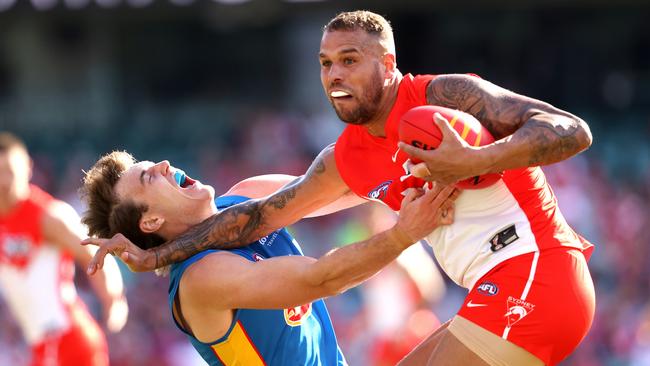 Lance Franklin fends off Gold Coast’s Charlie Ballard. Picture: Phil Hillyard