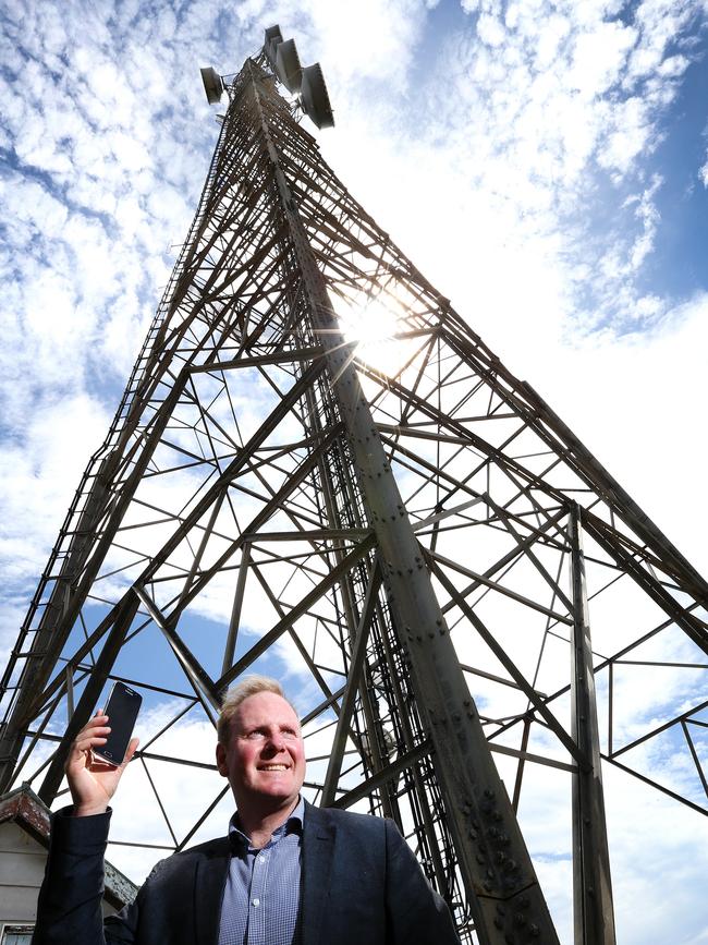 Telstra area manager Michael Patterson in front of the upgraded transmission tower on King Island