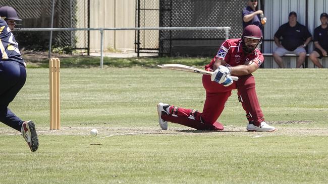 DDCA: North Dandenong batter Austin Heldt sweeps. Picture: Valeriu Campan