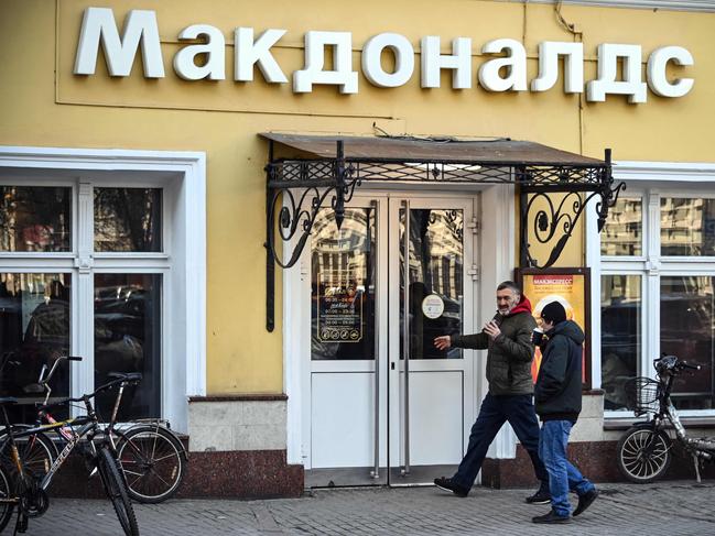 (FILES) In this file photo taken on March 09, 2022, people enter a McDonald's restaurant in Moscow. – U.S. fast-food giant McDonald's, which closed its stores in Russia in early March, announced on May 16, 2022 that it was pulling out of the country and selling all its operations in response to the Russian invasion of Ukraine. (Photo by AFP)