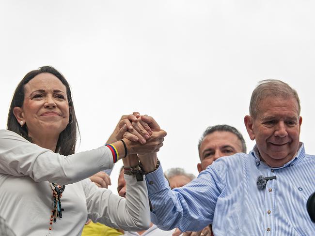 CARACAS, VENEZUELA - JULY 30: Opposition leader Maria Corina Machado and opposition presidential candidate Edmundo Gonzalez join hands during a protest against the result of the presidential election on July 30, 2024 in Caracas, Venezuela. President of Venezuela Nicolas Maduro was declared as the winner of the 2024 presidential election over his rival, Edmundo Gonzalez. The result has been questioned by the opposition and internationally. According to the opposition leader Maria Corina Machado, the result announced by the 'Consejo Nacional Electoral' (CNE) does not reflect the decision made by the Venezuelans during the election. (Photo by Alfredo Lasry R/Getty Images)