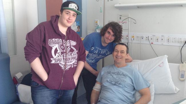 Anthony Takken with his sons Caleb and Travis during treatment.