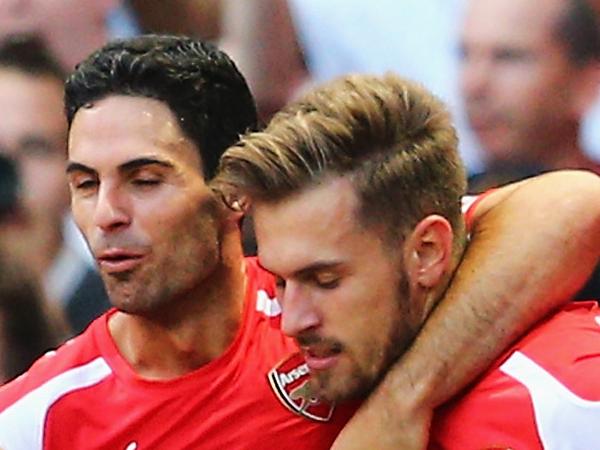 LONDON, ENGLAND - AUGUST 16: Aaron Ramsey (R) of Arsenal celebrates his goal with team mate Mikel Arteta during the Barclays Premier League match between Arsenal and Crystal Palace at Emirates Stadium on August 16, 2014 in London, England. (Photo by Clive Mason/Getty Images)