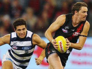 MELBOURNE, AUSTRALIA - MAY 13:  Joe Daniher of the Bombers runs with the ball away from Nakia Cockatoo of the Cats during the round eight AFL match between the Essendon Bombers and the Geelong Cats at Melbourne Cricket Ground on May 13, 2017 in Melbourne, Australia.  (Photo by Michael Dodge/Getty Images)