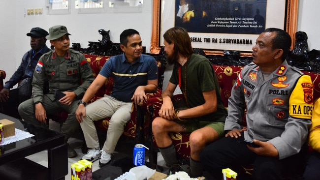 Phillip Mehrtens with Indonesian police and security officials from Operation Peaceful Cartenz at police HQ in Timika after his release.