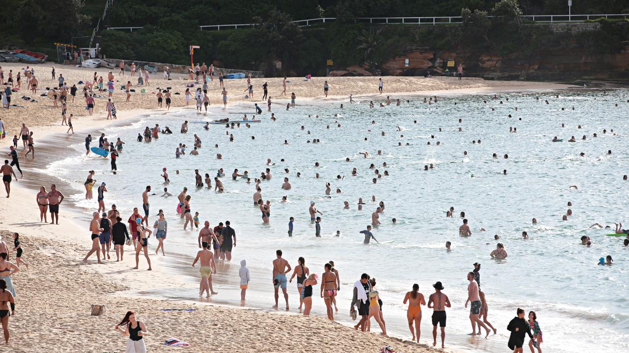 People flocked to the ocean despite the new rule that bans anything other than exercise on the beach. Picture: Adam Yip