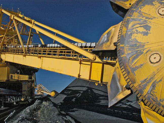 Bucketwheel reclaimers ride on rails between huge coal stockpiles at the Port Waratah coal loading facility in Newcastle, Australia Tuesday, June 1, 2004. Australian exports rose to the second highest on record in October, narrowing the trade deficit more than expected, as miners including Portman Ltd. and BHP Billiton earned more from commodity shipments to China. Photographer: Gillianne Tedder/Bloomberg News