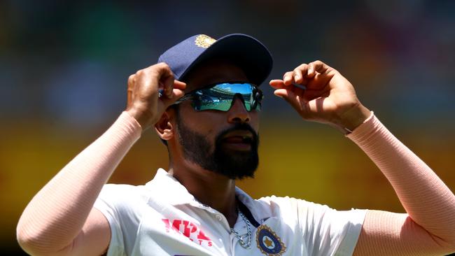 India's paceman Mohammed Siraj adjusts his glasses on day one of the fourth cricket Test match between Australia and India at the Gabba in Brisbane on January 15, 2021. (Photo by Patrick HAMILTON / AFP) / —IMAGE RESTRICTED TO EDITORIAL USE – STRICTLY NO COMMERCIAL USE —