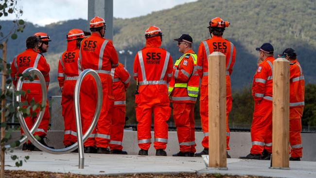 SES volunteers conduct a line search on a nearby oval. Picture: Jay Town