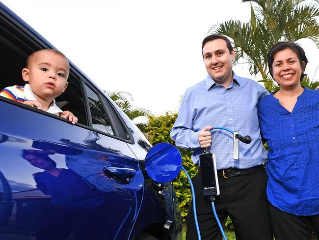 The future is electric: Jonathan and Michelle Curro, with baby Matteo, charge up their electric car at home in McDowall. Picture: AAP/John Gass