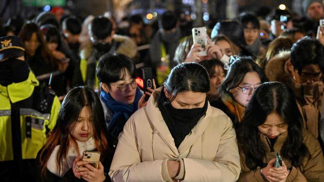 People pay tribute to the victims of the Jeju Air plane crash during a countdown event in central Seoul before midnight on December 31, 2024. Picture: Jung Yeon-je/AFP