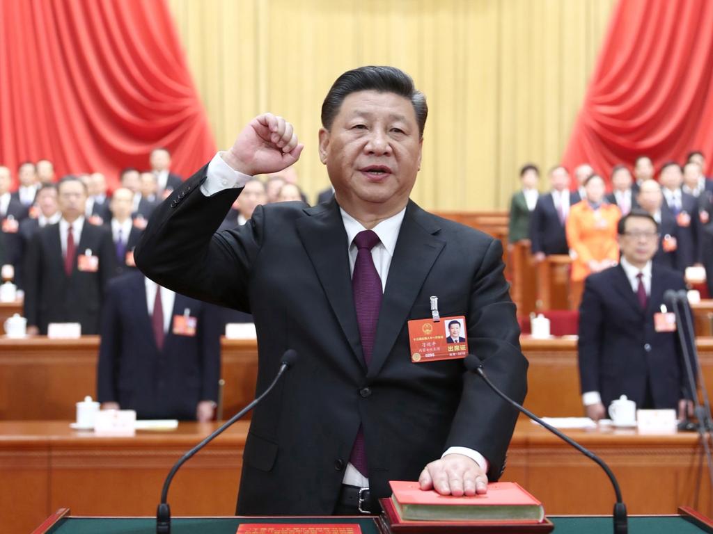 Xi Jinping takes a public oath of allegiance to the Constitution in the Great Hall of the People in Beijing. Picture: Ju Peng/Xinhua