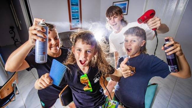 Elijah Gunn, 8, celebrates winning the best mullet with his siblings Kayden, 13, Macalister, 15 and Braithan, 10. Picture: Nigel Hallett