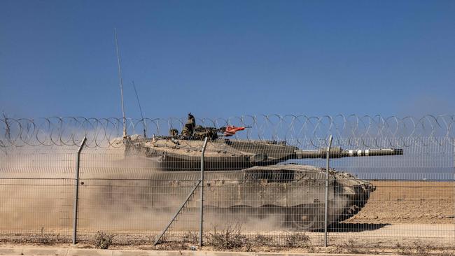 Defence: A Merkava tank on the move near Kibbutz Beeri last October 20. Picture: AFP